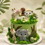 Jungle Friends safari buttercream cake with elephant, giraffe, lion and jungle animal decorations